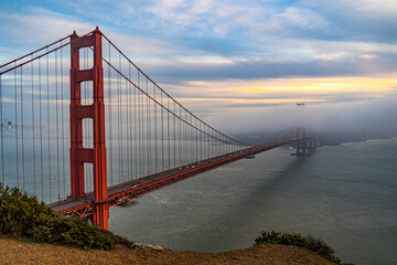 Sunset view of the Golden Gate Bridge and fog from Battery Spencer. 