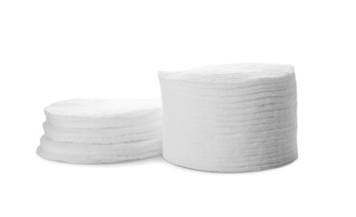 Stacks of cotton pads on white background
