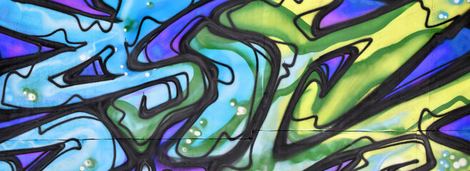 Colorful background of graffiti painting artwork with bright aerosol strips and beautiful colors. Old school street art piece made with aerosol spray paint cans. Contemporary youth culture backdrop