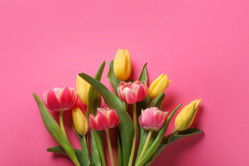 Many beautiful tulips on pink background, flat lay. Space for text