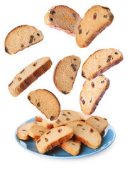 Sweet hard chuck crackers with raisins falling into plate on white background