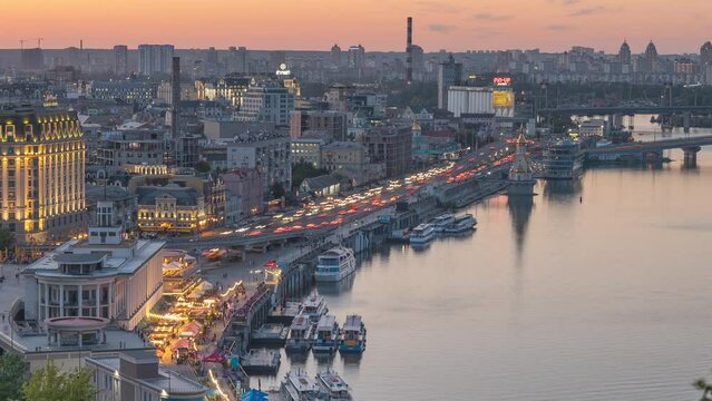 Kyiv, Ukraine sunset skyline | cityline time-lapse. Podil, Postal (Poshtova) square and Dnipro river embankment. City life video. traffic jam.