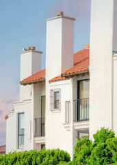 Vertical Puffy clouds at sunset White residential building at La Jolla, California