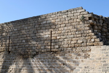 Stone wall of an ancient fortress on the seashore in Israel.