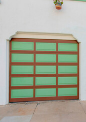 Vertical Two garage doors with brown grid lines and green panels at La Jolla, California