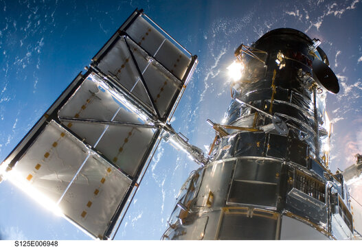 Space shuttle satellite in outer space near planet earth. Digitally enhanced. Elements of this image furnished by NASA.