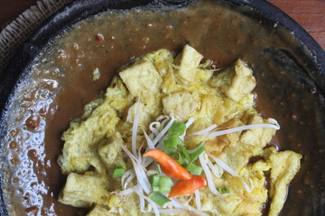 Egg tofu is a dish typical of East Java, Indonesia, which consists of fried tofu covered in beaten egg.  usually consumed with the addition of peanut sauce