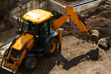 The work of an excavator at a construction site.