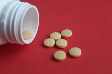 medicine tablet granules are yellow on a red background