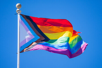 Close-up of Rainbow flag (LGBT movement) waving in the wind. 