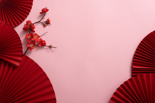 Chinese New Year celebration background with red paper fans and flowers. Asia traditional cultural decoration. Empty space. decoration backdrop idea for the year-end party.