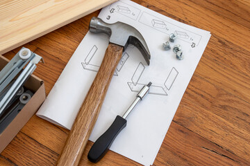 home furniture assembly, close up of tools and a manual