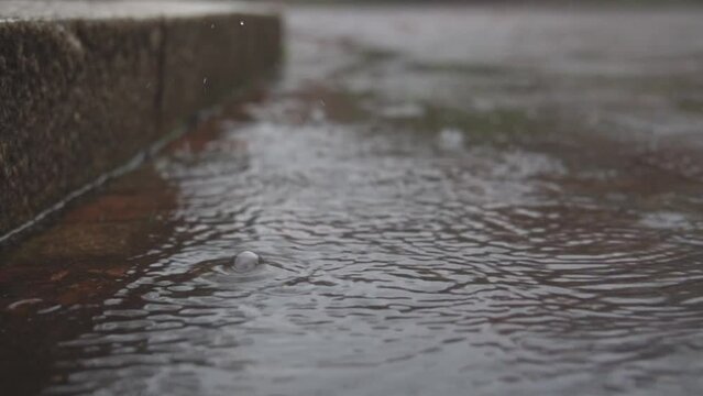 Slow Motion Of Rain Falling On The Road.