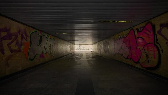 Underground passage, tunnel, underground pedestrian passage. 
Graffiti is painted on the walls.