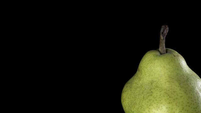 Fruit close whole Pear Spinning and Rotating Isolated on black Background