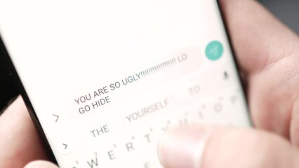 Cyber Bullying Sending Hateful Text Message on Smartphone