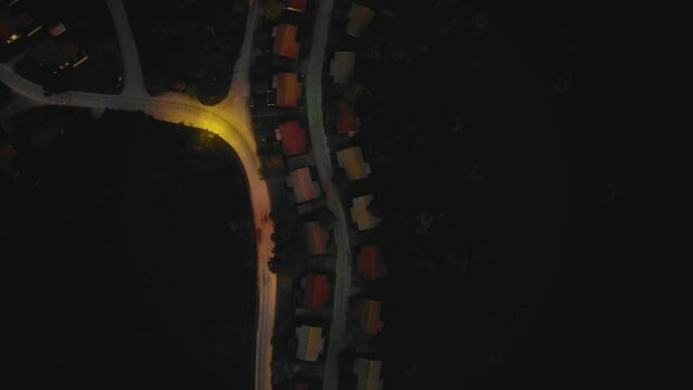 Amazing cinematic 4K residential drone footage consists of many homes, main road, trees, lake and infrastructure in the middle of tropical forest located in Riau, Indonesia during sunset.