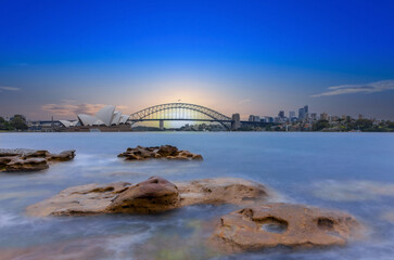 Fototapeta premium Sydney Harbour Australia at Sunset with the turquoise colours of the bay and high rise offices of the City in the background