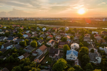Aerial view of residential houses in suburban rural area at sunset