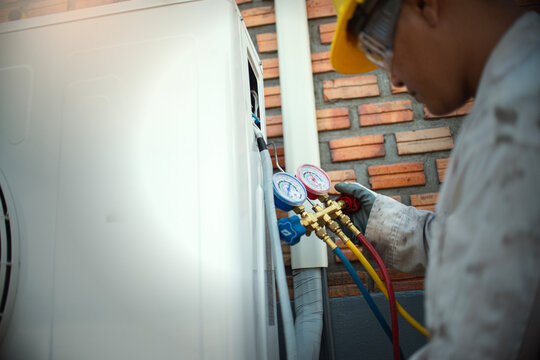 Technician is checking air conditioner ,measuring equipment for filling air conditioners..