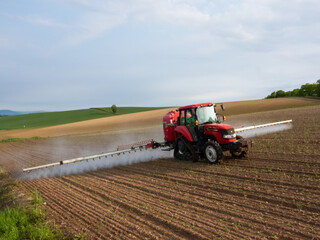 Tractor doing farm work in spring field