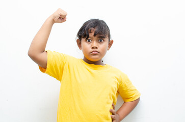 Portrait of happy asian little girl posing yes gesture with raising her fist shows growing up and strong.