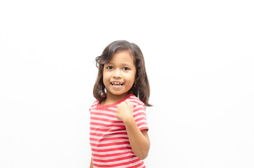 Portrait of happy asian little girl posing yes gesture with raising her fist shows growing up and strong.