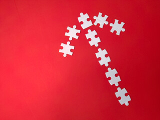White puzzles arranged according to the shape of arrows on a red background.