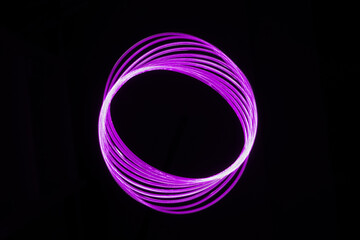 2022-11-30 ABSTRACT NEON LIGHT SWIRL ON A BLACK BACKGROUND