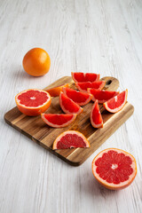 Organic Red Ruby Grapefruit on a Wooden Board, side view.