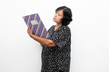 asian senior woman thinking while holding book account managing household livingcost