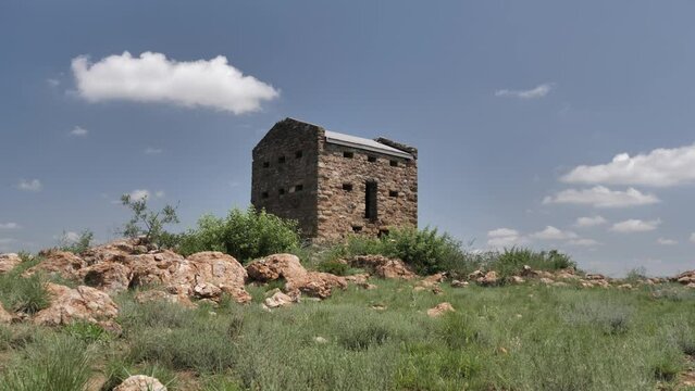 Cloud drifts over historic Boer War stone masonry blockhouse, South Africa