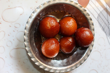 Indian sweet food Gulab Jamun served in a steel bowl. indian sweet gulab jamun closeup view
