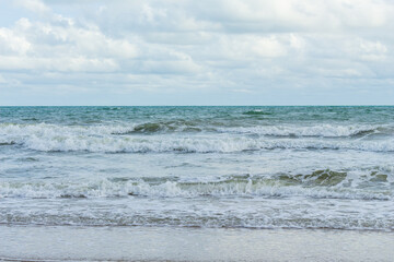 Sea waves are splashing on the shore.