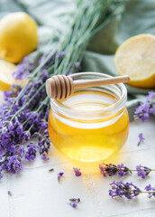 Fototapeta na wymiar Jar with honey and fresh lavender flowers