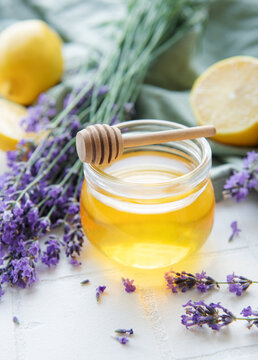 Jar with honey and fresh lavender flowers