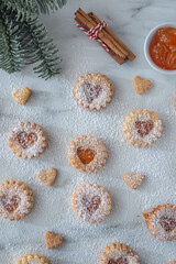 sweet home made linzer christmas cookies filled with apricot jam on a table