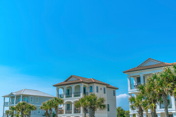 Destin, Florida- Front exterior of beach homes against the blue sky