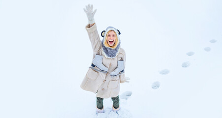 Woman with skates over shoulder in freezing winter day. Winter holiday. Attractive young woman in wintertime outdoor. Funny winter girl is going skate outdoors. Winter woman portrait for banner.