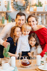 Beautiful big family in the kitchen with Christmas decor. to cook together.