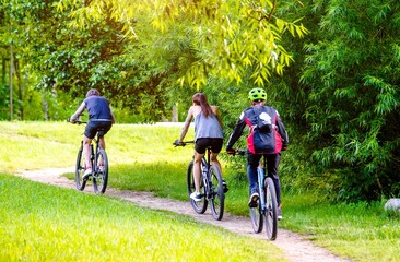 Cyclists ride on the bike path in the city Park
