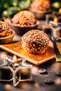 Small chocolate pastry cakes for Christmas with candles and ornaments
