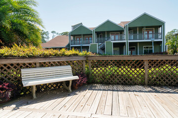Business plaza with white bench and wood deck near the beach in Destin Florida