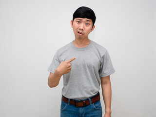 Male employee point finger at himself feels confused why me isolated