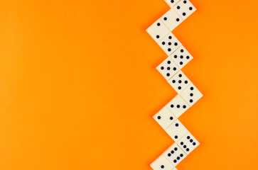 White domino stacked herringbone on an orange background