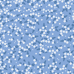 Cute floral pattern. Seamless vector texture. An elegant template for fashionable prints. Print with small white flowers ,dark blue leaves. blue  background.