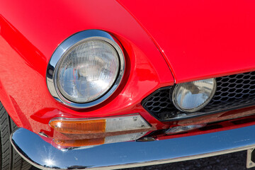 Obraz na płótnie Canvas Detail of an headlight of a vintage italian red sport car