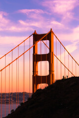 Golden Gate with people silhouette at sunset