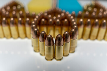 Bullets 9 mm, coat of arms and flag of Ukraine - obrazy, fototapety, plakaty