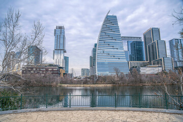 Fototapeta premium Colorado river with reflection of the buildings view from Butler Metro Park- Austin, Texas